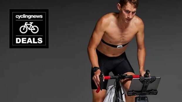 A cyclist riding indoors wearing a Garmin HRM Pro heart rate monitor