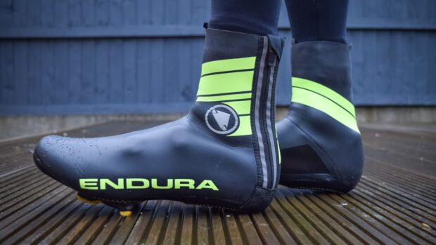 Endura Road overshoe Hi viz oveshoes worn on some wooden decking