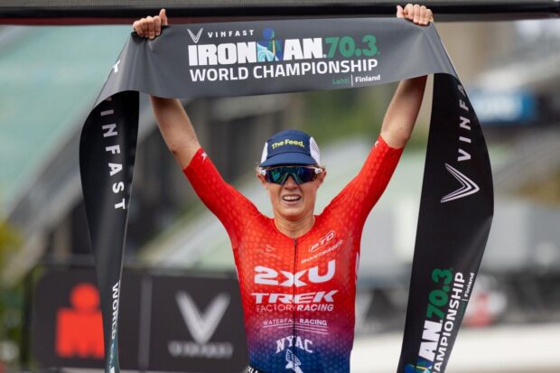 Taylor Knibb celebrates her Ironman 70.3 World Championships victory in Finland in 2023