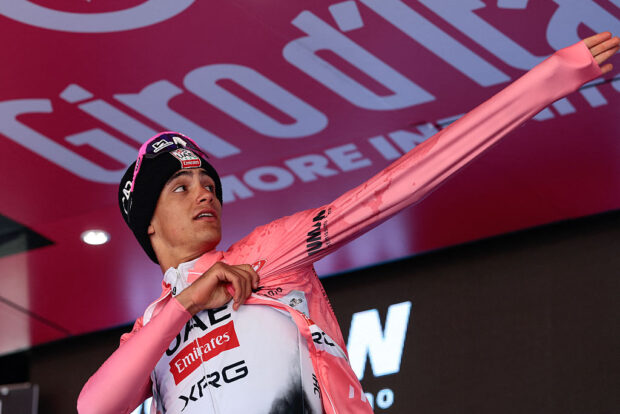 Giro d'Italia: Leader Isaac del Toro pulls on the pink jersey on the podium after stage 19