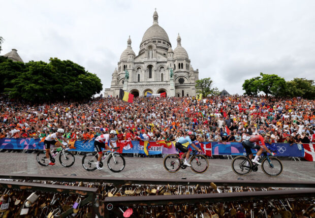 PARIS FRANCE AUGUST 03 LR Juan Ayuso of Team Spain Felix Grossschartner of Team Austria Remco Evenepoel of Team Belgium Attila Valter of Team Hungary compete passing by the Basilica of the Sacre Coeur while fans cheers during the Mens Road Race on day eight of the Olympic Games Paris 2024 at trocadero on August 03 2024 in Paris France Photo by Alex BroadwayGetty Images