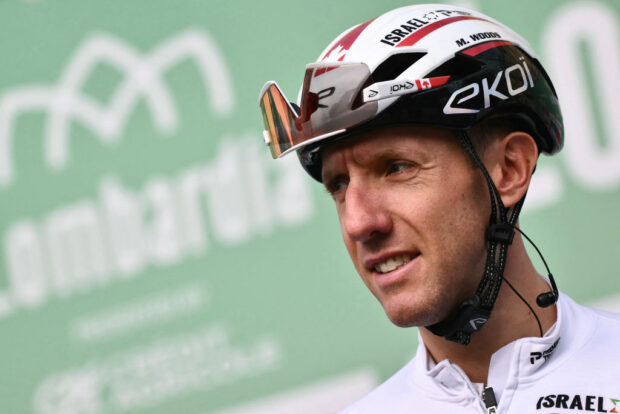 Israel - Premier Tech team's Canadian rider Michael Woods looks on from the presentation podium before the start of 118th edition of the Giro di Lombardia (Tour of Lombardy), a 252km cycling race from Bergamo to Como on October 12, 2024. (Photo by Marco BERTORELLO / AFP) (Photo by MARCO BERTORELLO/AFP via Getty Images)
