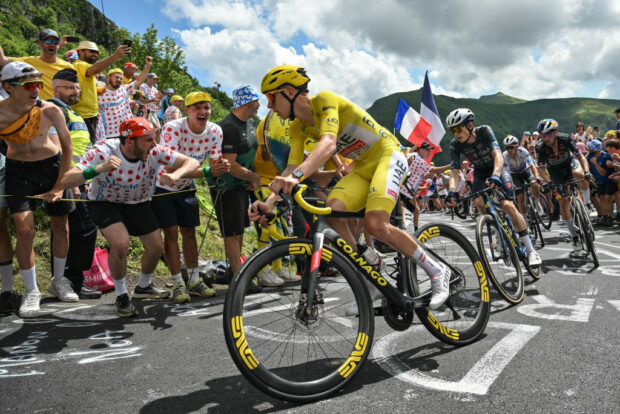 UAE Team Emirates team's Slovenian rider Tadej Pogacar wearing the overall leader's yellow jersey (C) cycles ahead of Team Visma - Lease a Bike team's Danish rider Jonas Vingegaard (2nd L), Red Bull - BORA - hansgrohe team's Slovenian rider Primoz Roglic and Soudal Quick-Step team's Belgian rider Remco Evenepoel wearing the best young rider's white jersey (rear) in the ascent of Pas de Peyrol (Puy Mary) during the 11th stage of the 111th edition of the Tour de France cycling race, 211 km between Évaux-les-Bains and Le Lioran, in the Massif Central mountains of central France, on July 10, 2024. (Photo by Marco BERTORELLO / AFP) (Photo by MARCO BERTORELLO/AFP via Getty Images)