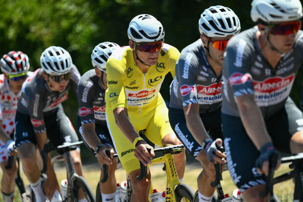 Alpecin - Deceuninck team's Dutch rider Mathieu van der Poel wearing the overall leader's yellow jersey cycles with his teammates in the pack of riders (peloton) during the 7th stage of the 112th edition of the Tour de France cycling race, 197 km between Saint-Malo and Mur-de-Bretagne Guerledan, in Brittany, western France, on July 11, 2025. (Photo by Marco BERTORELLO / AFP)