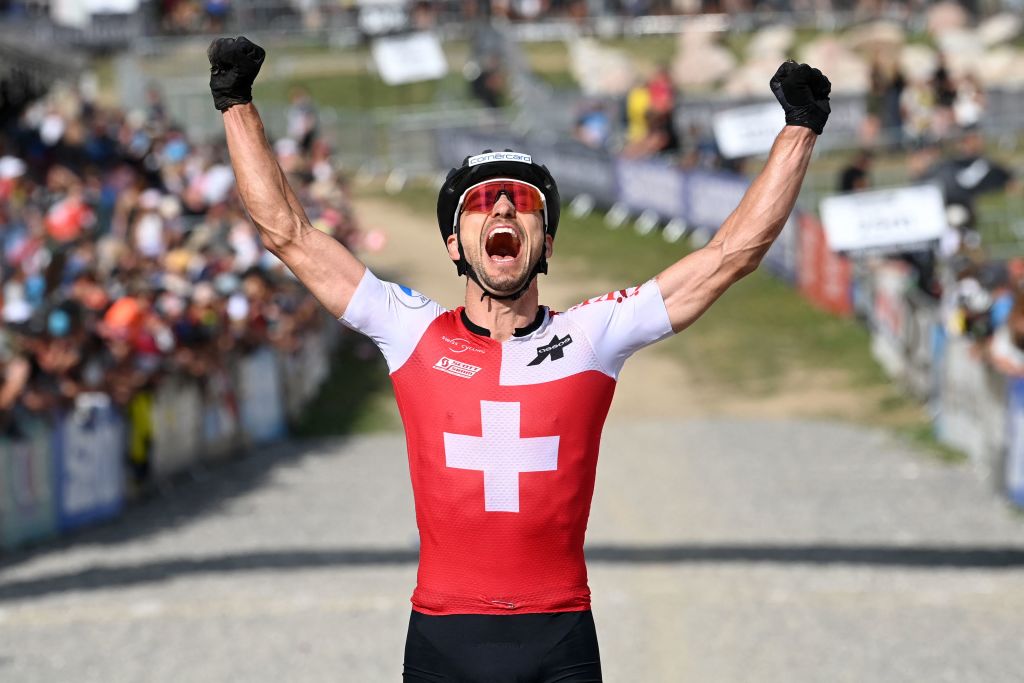 Swiss cyclist Nino Schurter celebrates after winning the men's elite olympic cross-country event at the UCI Mountain Bike World Championships 2022 in Les Gets, south-eastern France, on August 28, 2022. (Photo by OLIVIER CHASSIGNOLE / AFP) (Photo by OLIVIER CHASSIGNOLE/AFP via Getty Images)
