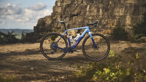 A Trek Checkpoint+ in front of a rocky cliff