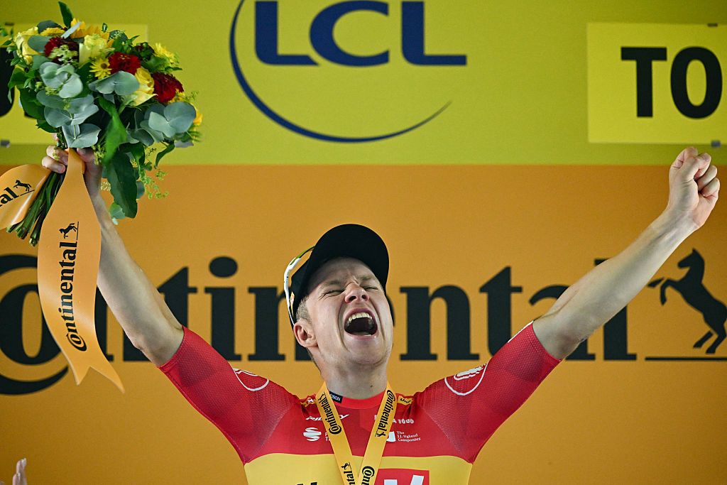 Uno-X Mobility team's Norwegian rider Jonas Abrahamsen celebrates on the podium after winning the 11th stage of the 112th edition of the Tour de France cycling race, 156.8 km starting and finishing in Toulouse, southwestern France, on July 16, 2025. (Photo by Loic VENANCE / AFP)