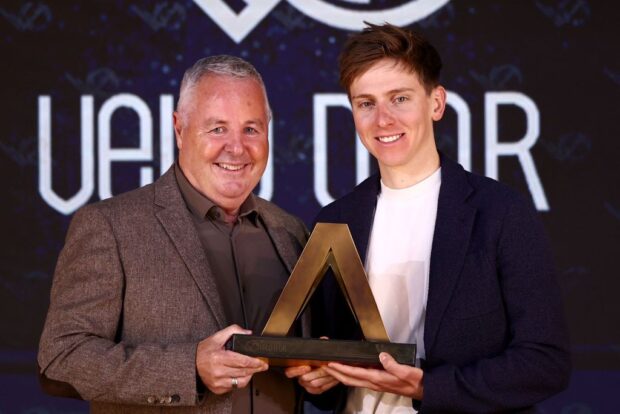 Slovenian rider Tadej Pogacar (R) receives the men's Velo d'Or trophy from Irish former rider Stephen Roche during the Velo d'Or 2024 award ceremony at the Pavillon Gabriel in Paris on December 6, 2024. (Photo by Anne-Christine POUJOULAT / AFP)