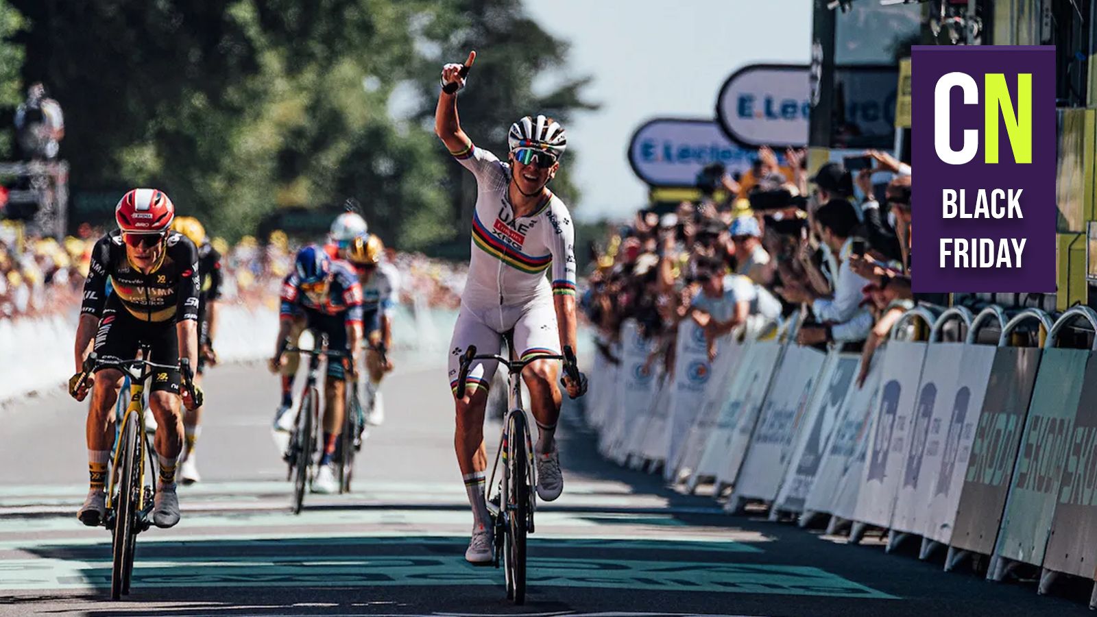 Tadej Pogačar crossing the line celebrating with the Cyclingnews Black Friday logo