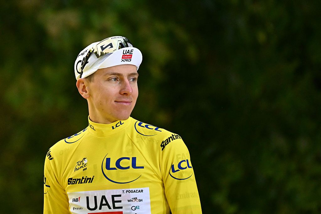 UAE Team Emirates - XRG team's Slovenian rider Tadej Pogacar celebrates on the podium with the overall leader's yellow jersey after the 21st and final stage of the 112th edition of the Tour de France cycling race, 132.3 km between Mantes-la-Ville and Paris Champs-Élysees, on July 27, 2025. (Photo by Loic VENANCE / AFP)