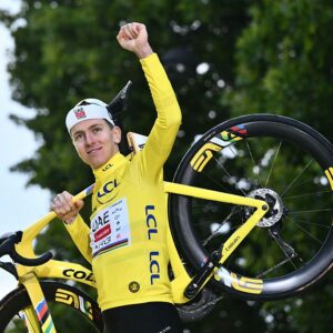 TOPSHOT - UAE Team Emirates - XRG team's Slovenian rider Tadej Pogacar celebrates on the podium with the overall leader's yellow jersey after the 21st and final stage of the 112th edition of the Tour de France cycling race, 132.3 km between Mantes-la-Ville and Paris Champs-Élysees, on July 27, 2025. (Photo by Marco BERTORELLO / AFP) (Photo by MARCO BERTORELLO/AFP via Getty Images)