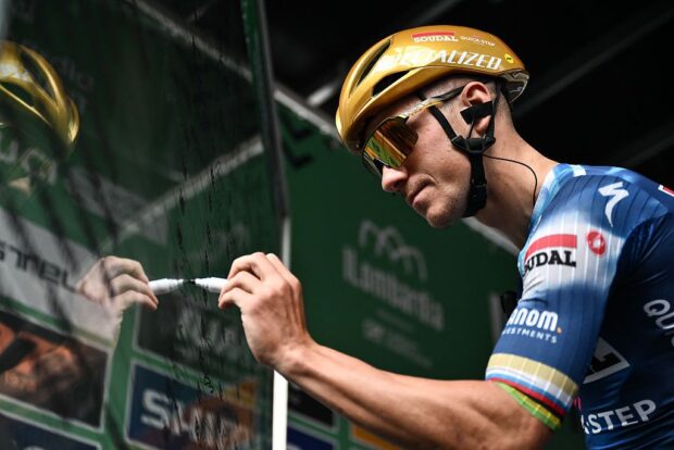 Soudal Quick-Step’s Belgian rider Remco Evenepoel signs in, ahead of the 119th edition of the Giro di Lombardia (Tour of Lombardy), a 238km cycling race from Como to Bergamo on October 11, 2025. (Photo by Marco BERTORELLO / AFP)