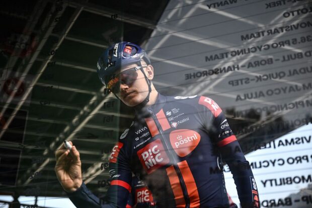 Team Picnic PostNL’s British rider Oscar Onley looks on from the sign-in podium ahead of the 119th edition of the Giro di Lombardia (Tour of Lombardy), a 238km cycling race from Como to Bergamo on October 11, 2025. (Photo by Marco BERTORELLO / AFP)