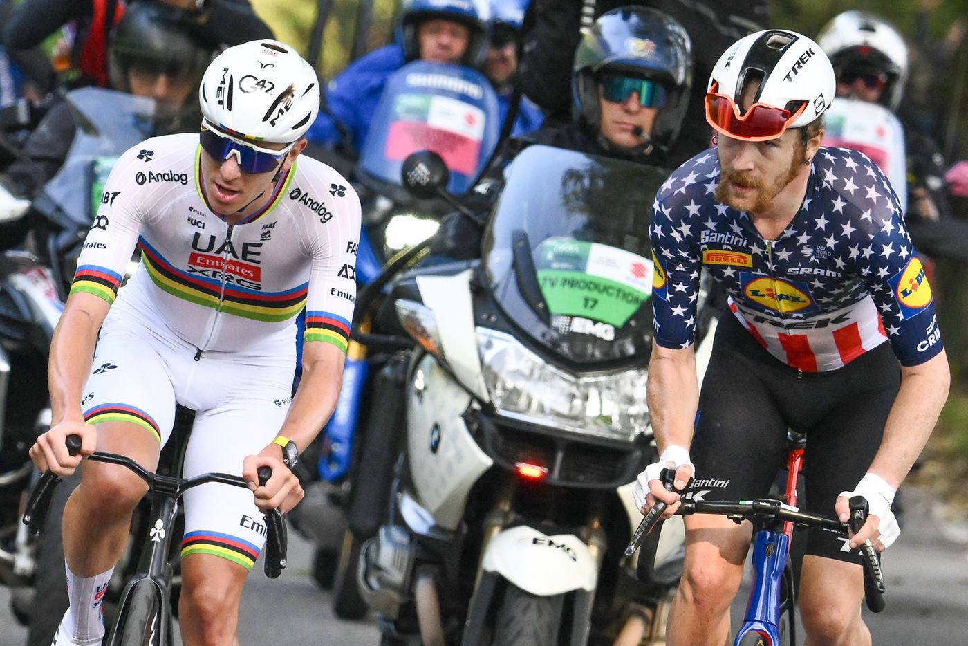 UAE Team Emirates's Slovenian rider Tadej Pogacar (L) attacks to take the lead past Lidl-Trek's US rider Quinn Simmons (R), in the Passo Di Ganda ascent during the 119th edition of the Giro di Lombardia (Tour of Lombardy), a 238km cycling race from Como to Bergamo on October 11, 2025. (Photo by Marco BERTORELLO / AFP) (Photo by MARCO BERTORELLO/AFP via Getty Images)