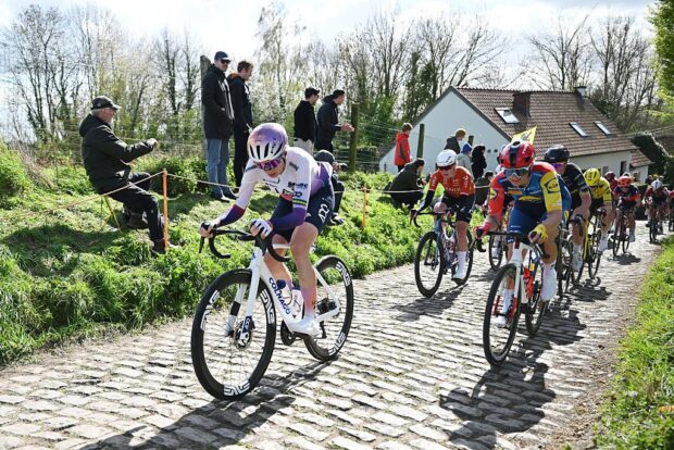 Brodie Chapman leads a group over a cobbled climb during the Tour of Flanders