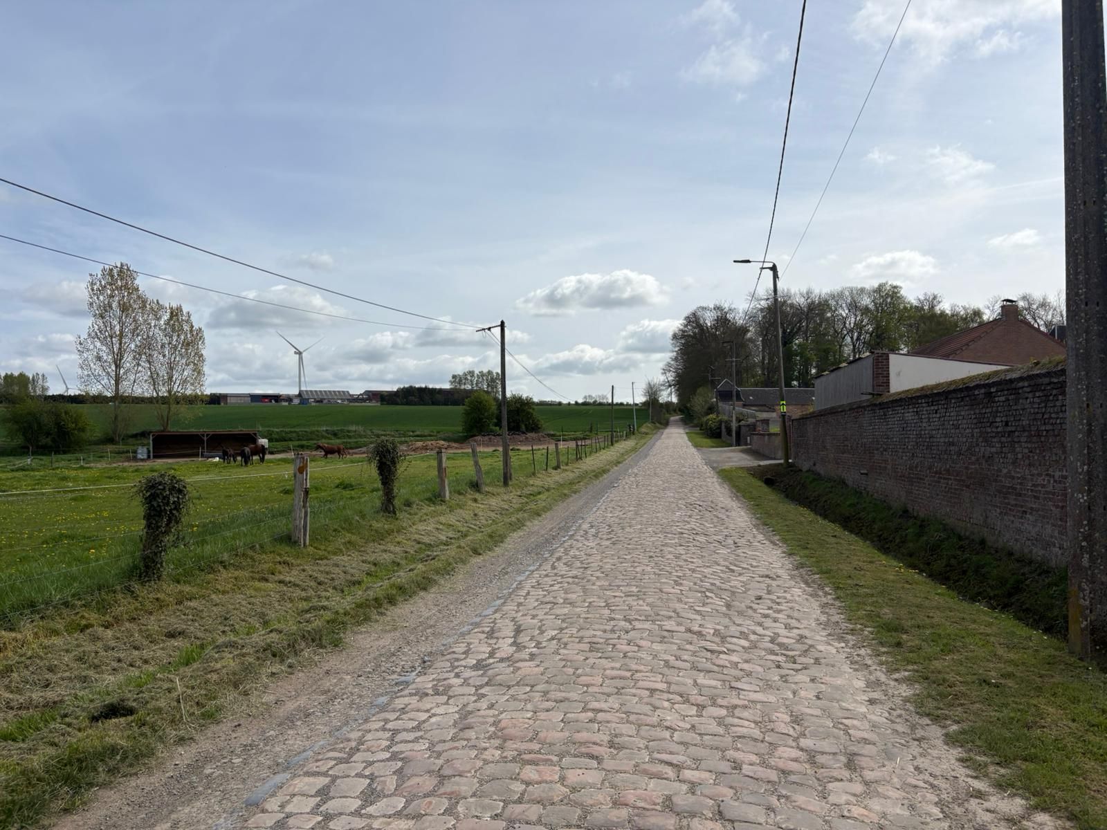 Wide shots of the cobbled section at Briastre, to be used in Paris-Roubaix 2026. The photos show relatively smooth cobbles and a gentle uphill