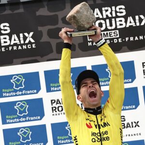 Winner Team Visma - Lease a Bike's Belgian rider Wout van Aert celebrates on the podium of the 123rd edition of the Paris-Roubaix