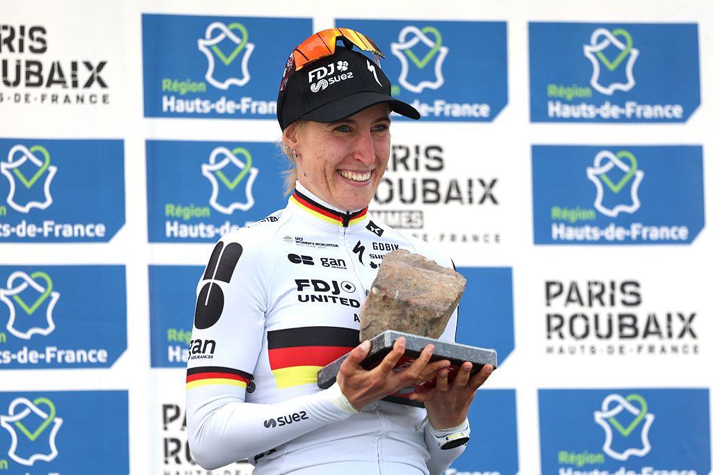 Franziska Koch of Germany and Team FDJ United - SUEZ celebrates at podium as race winner with the cobblestone-race-trophy