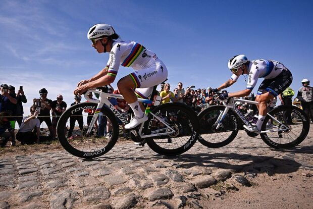 Side shot of Lotte Kopecky leading Lorena Wiebes over a rough cobbled sector during Paris-Roubaix 2025