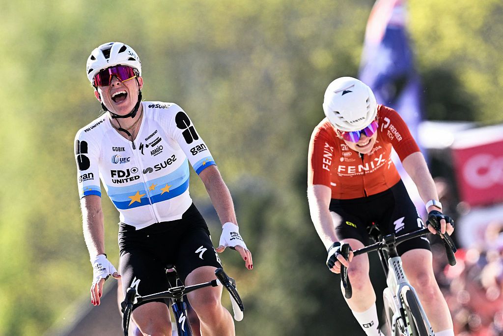 FDJ United - Suez's Dutch Demi Vollering celebrates as she crosses the finish line next to Fenix-Premier Tech's Dutch Puck Pieterse to win 'La Fleche Wallonne'