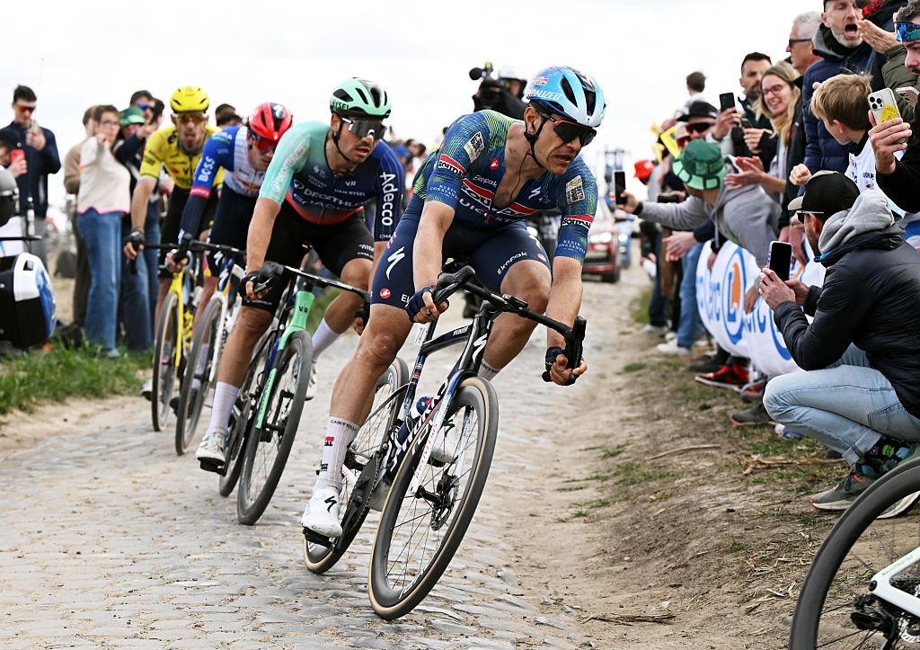 Jasper Stuyven leads a chasing group around a dusty, cobbled corner during Paris-Roubaix 2026
