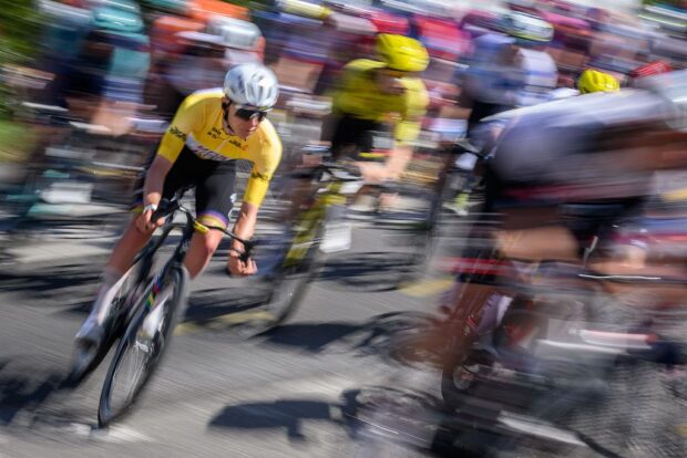 Riders of the men's WorldTour peloton race uphill during stage 2 of the 2026 Tour de Romandie