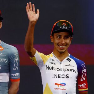 Egan Bernal smiles and waves on stage during the Giro d'Italia team presentation