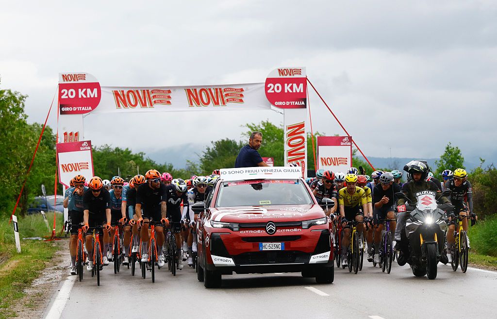 Italy's race director and former cyclist Marco Velo talks with rides after a crash during the 2nd stage of the Giro d'Italia 2026 - Tour of Italy cycling race between Burgas and Veliko Tarnovo, Bulgaria, on May 9, 2026. (Photo by Luca Bettini / AFP)