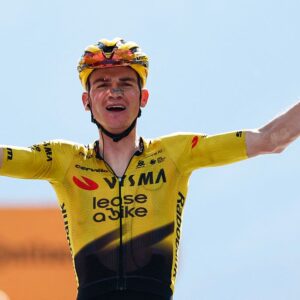 Team Visma Lease a Bike US rider Sepp Kuss celebrates as he crosses the finish line to win the 19th stage of the Giro d'Italia 2026