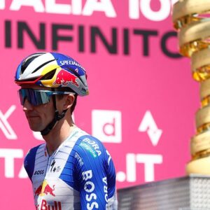 Red Bull - BORA - hansgrohe Australian rider Jai Hindley walks past the trophy on stage before the 15th stage of the Giro d'Italia 2026 - Tour of Italy cycling race between Voghera and Milan, Italy, on May 24, 2026. (Photo by Luca Bettini / AFP)