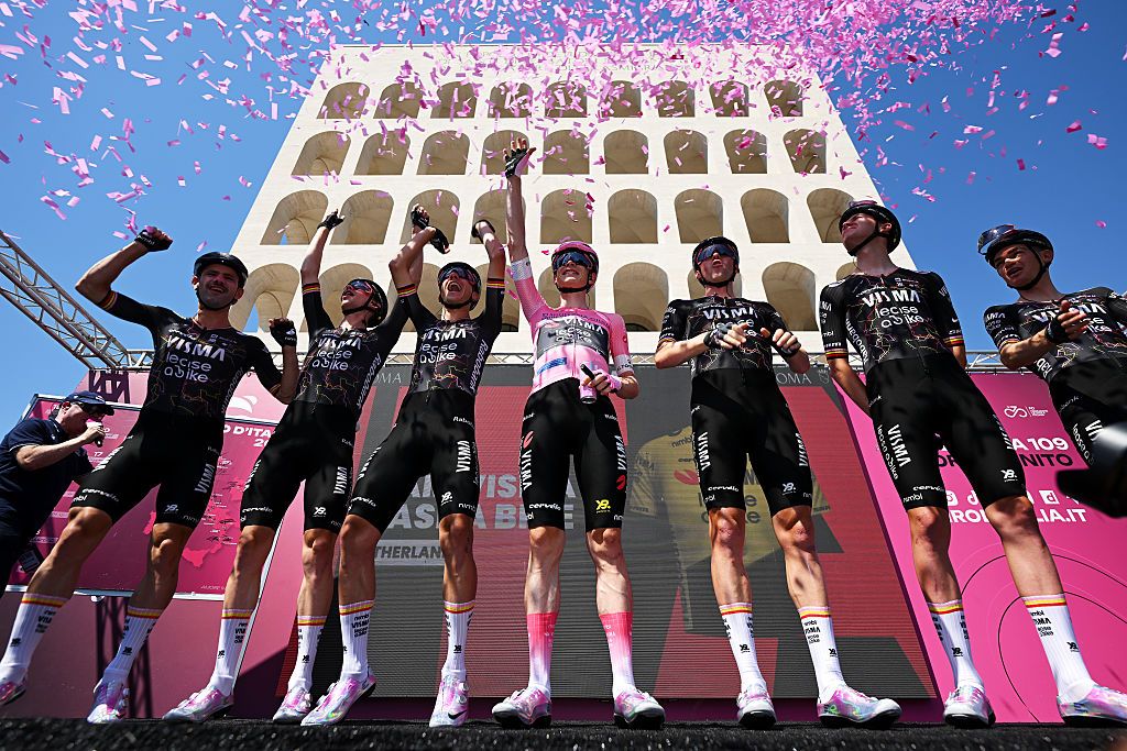 Visma in their alternate jerseys on the sign-on podium in Rome amid pink confetti