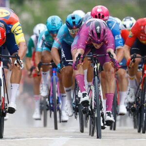 Paul Magnier (C) wearing the points classification mauve jersey (Maglia Ciclamino) sprint to win next to Lidl - Trek Italian rider Jonathan Milan in the 3nd stage of the Giro d'Italia 2026