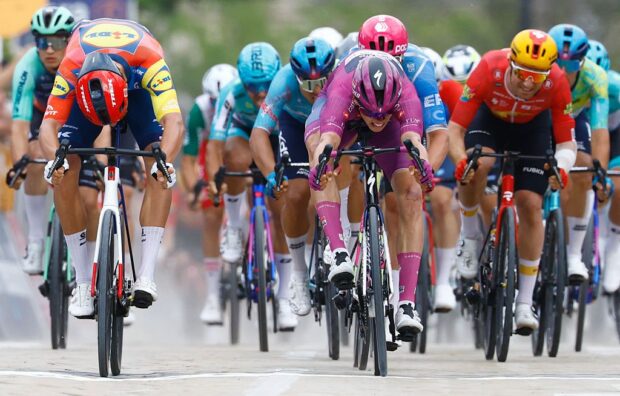 Paul Magnier (C) wearing the points classification mauve jersey (Maglia Ciclamino) sprint to win next to Lidl - Trek Italian rider Jonathan Milan in the 3nd stage of the Giro d'Italia 2026