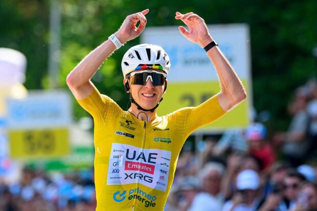 Tadej Pogacar celebrates as he crosses the finish line to win the fifth and final stage of the Tour de Suisse