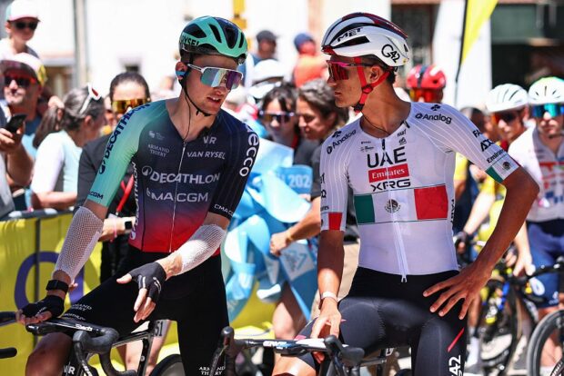 Paul Seixas (L) and Isaac Del Toro Romero speak at the start line before the 8th and final stage of the Tour Auvergne-Rhone-Alpes