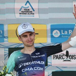 Decathlon CMA CGM Team's French rider Paul Seixas celebrates on the podium with the most combative rider award after the 7th stage of the Tour Auvergne-Rhone-Alpes cycling race (formerly known as the Criterium du Dauphine), 133,6km between La Bridoire and Grand Colombier in the French Alps on June 13, 2026. (Photo by Anne-Christine POUJOULAT / AFP)