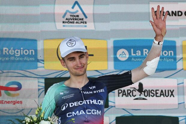 Decathlon CMA CGM Team's French rider Paul Seixas celebrates on the podium with the most combative rider award after the 7th stage of the Tour Auvergne-Rhone-Alpes cycling race (formerly known as the Criterium du Dauphine), 133,6km between La Bridoire and Grand Colombier in the French Alps on June 13, 2026. (Photo by Anne-Christine POUJOULAT / AFP)
