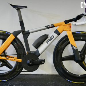 A Toot Racing bike leaning against a white wall