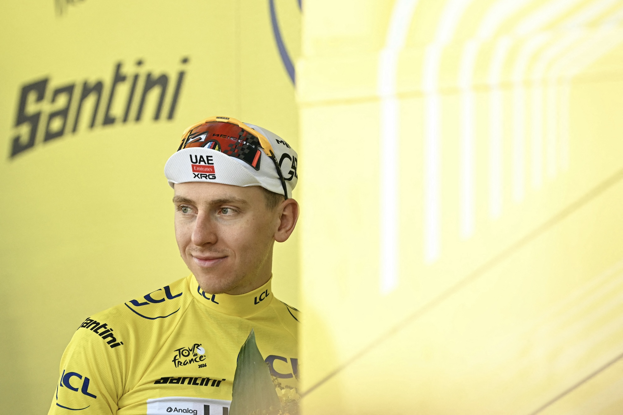 UAE Team Emirates: el ciclista esloveno de XRG, Tadej Pogacar, celebra en el podio con el maillot amarillo de líder general después de la novena etapa de la 113.ª edición de la carrera ciclista del Tour de Francia, 154,6 km entre Malemort y Ussel, en el centro de Francia, el 12 de julio de 2026. (Foto de Loic VENANCE / AFP)