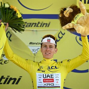UAE Team Emirates - XRG's Slovenian rider Tadej Pogacar celebrates on the podium with the overall leader's yellow jersey after the 16th stage of the 113th edition of the Tour de France cycling race, 26 km between Évian-les-Bains and Thonon-les-Bains in the French Alps, on July 21, 2026. (Photo by Loic VENANCE / AFP)
