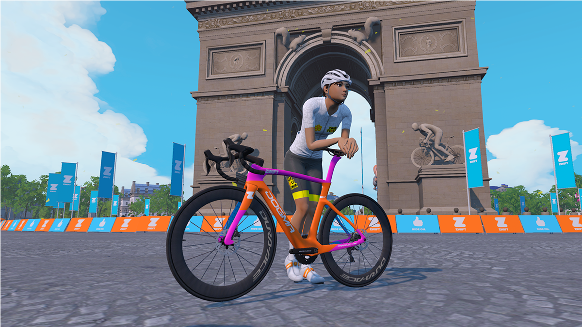 A photo of a Zwift avatar leaning against a pink and orange Pinarello Dogma in the game