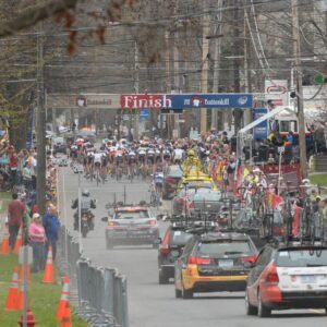 Professional bicycle riders followed by team support cars go through town during the Tour of the Battenkill race on Sunday, April 15, 2012 in Cambridge, NY.