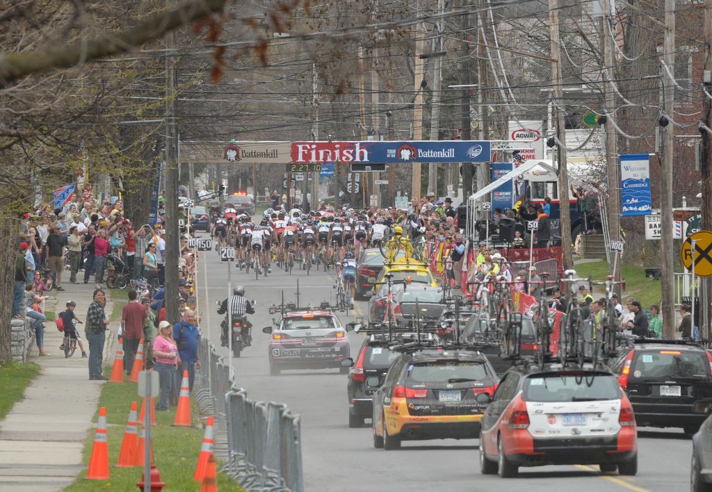 Professional bicycle riders followed by team support cars go through town during the Tour of the Battenkill race on Sunday, April 15, 2012 in Cambridge, NY.
